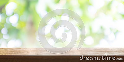 Empty wooden table top with blurred green garden background. Pan Stock Photo