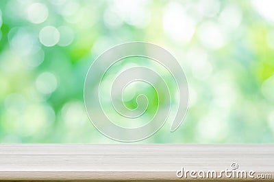 Empty wooden table top with blurred green natural abstract background. Stock Photo
