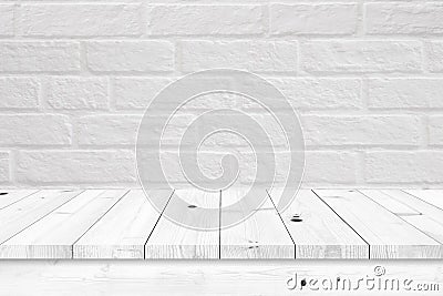 Empty wooden table with white brick wall background. Stock Photo