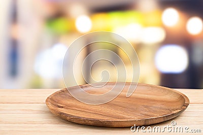 Empty wooden tray on perspective wooden table on top over blurcoffee shop background. Can be used mock up for montage products di Stock Photo