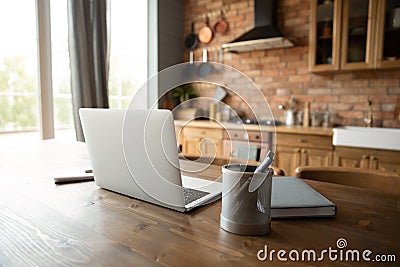 Empty workplace with laptop in home kitchen office Stock Photo