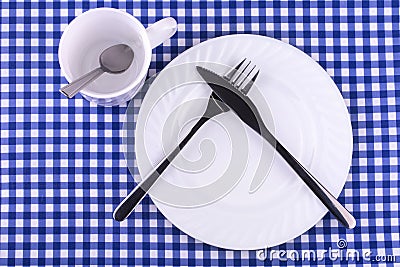 Empy Mug with spoon, plate with a knife and fork Stock Photo
