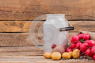 Enamelware milk churn and vegetables. Stock Photo