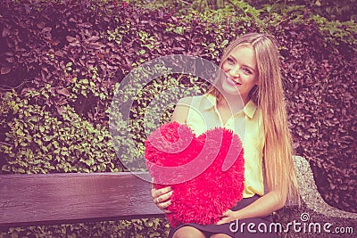 Enamored woman with big red heart Stock Photo