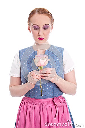 Enamoured young girl from Bavaria with a rose Stock Photo