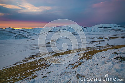 Enchanted view of Pian Grand at dusk with snow in Umbria Stock Photo