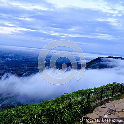 Enchanting blue sky with white clouds at the top and rising from the earth Stock Photo