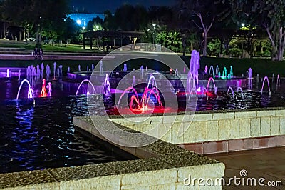 Enchanting grandiose musical performance - water and light show of a musical fountain on the embankment, in the center of the city Editorial Stock Photo