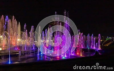 Enchanting grandiose musical performance - water and light show of a musical fountain on the embankment, in the center of the city Editorial Stock Photo