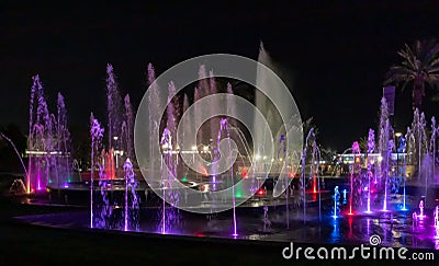 Enchanting grandiose musical performance - water and light show of a musical fountain on the embankment, in the center of the city Editorial Stock Photo