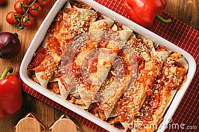 Enchiladas - mexican food, tortilla with chicken, cheese and tomatoes. Stock Photo
