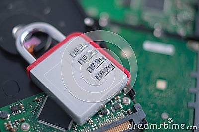 Encrypted hard disk. Padlock with cipher on an opened hard disk. Data loss. computer motherboard. the concept of data Stock Photo