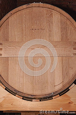 End of oak barrel, storing one year old, red wine Stock Photo