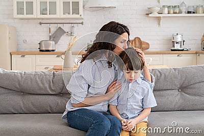 Ending of family fight: mother feel guilty embrace disobedient son after scolding for misbehavior Stock Photo