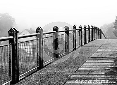 Endless bridge mist over lake-black and white Stock Photo