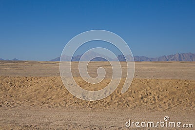 Endless desert tire marks on sand Stock Photo