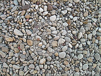 Endless dry sea pebbles, texture, background. Pebbles gray, small, oval. Stock Photo