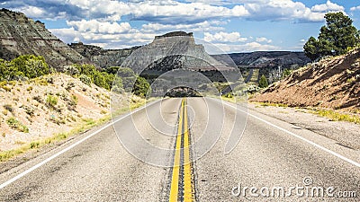 Endless empty road scenic Utah landscape with a sandstone mountain in the background Stock Photo