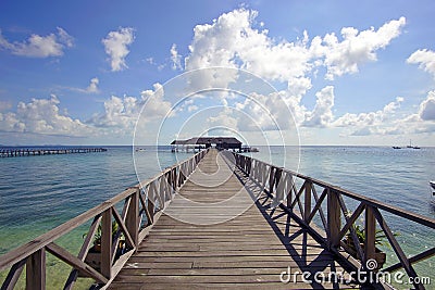 Endless jetty to the horizon; view to a turquoise sea and blue s Stock Photo