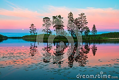 Endless polar day in the Arctic. Night time in July. Beautiful pink sky and its reflection in the glossy water of the lake. Stock Photo