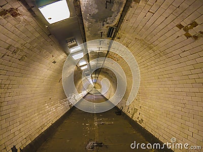 Endless tunnel under the Tames river. Eternal walking underground. Stock Photo