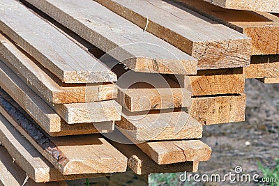 Ends of rough pine boards in the outdoor stack Stock Photo
