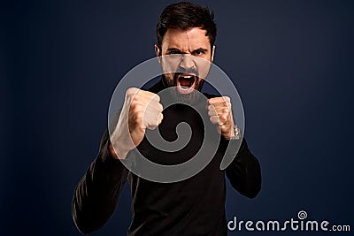 Endurance, motivated and power concept. Good-looking bearded man ready for fight, looking excited and determined, standing in Stock Photo
