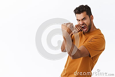 Endurance, motivated and power concept. Good-looking bearded man ready for fight, looking excited and determined Stock Photo