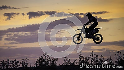 Enduro Bike jumping at sunset Stock Photo