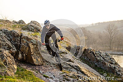 Enduro Cyclist Riding the Mountain Bike Down Beautiful Rocky Trail. Extreme Sport Concept. Space for Text. Stock Photo