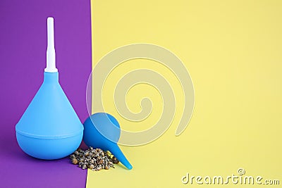 Enemas and dry chamomile on color background, space for text Stock Photo