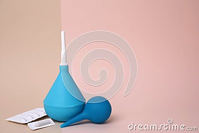 Enemas and suppositories on color background, space for text. Medical treatment Stock Photo
