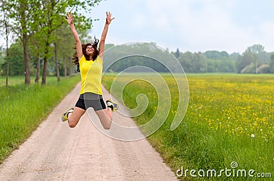 Energetic agile young woman leaping for joy Stock Photo