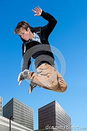 Energetic boy jumping in city. Stock Photo