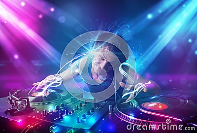 Energetic Dj mixing music with powerful light effects Stock Photo