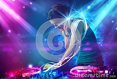 Energetic Dj mixing music with powerful light effects Stock Photo