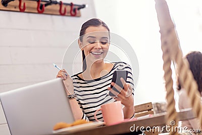 Energetic female freelancer receiving message Stock Photo