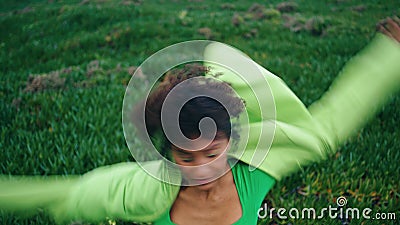 Energetic woman performer dancing on green grass. Girl practicing contemporary. Stock Photo