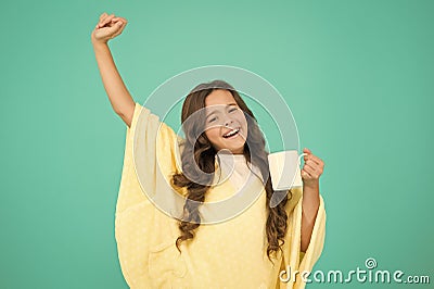 Energize morning. small kid blue background. little girl drink cocoa or milk before sleeping. cosy and fluffy pajama Stock Photo