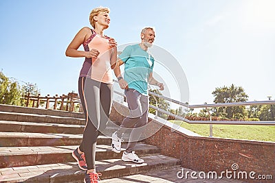 Energize your morning. Full length shot of active mature family couple in sportswear running together in the park on a Stock Photo