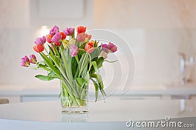 Energizing and colorful tulip flowers in a clean kitchen Stock Photo