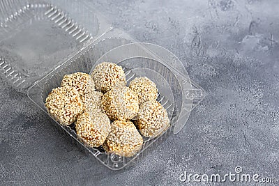 Energy bites without baking are made from ingredients - nuts, cocoa, chocolate, oats and sesame seeds. Located on a gray Stock Photo
