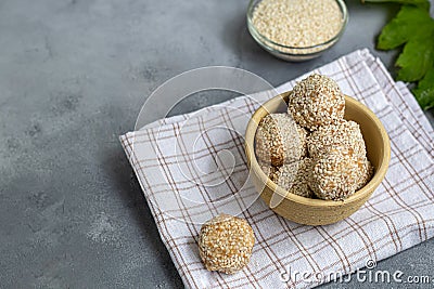 Energy bites without baking are made from ingredients - nuts, cocoa, chocolate, oats and sesame seeds. Located on a gray Stock Photo