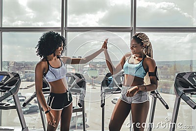 Two athlete woman giving high five in the gym Stock Photo