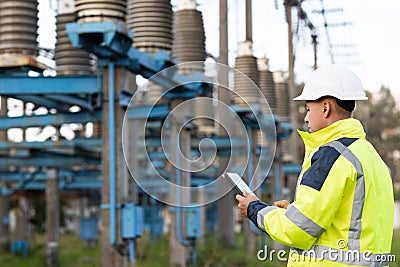 Energy business technology industry concept. Electrical engineer studying reading on tablet. Electrical worker engineer Stock Photo