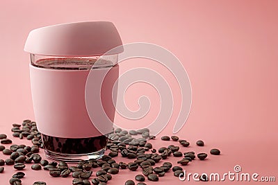 Energy drinks, morning routine and stimulant beverages concept glass and rubber cup of java surrounded by roasted coffee beans Stock Photo