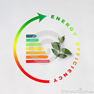 Energy efficiency rating and green leaves on light background Stock Photo