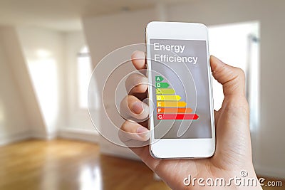 Energy efficiency rating on smartphone app, home interior in background Stock Photo