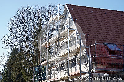 Energy renovation. House scaffolded and repainted. Stock Photo