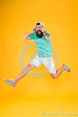 Energy of rhythm. Hipster dancing jumping headphones gadget. Inspiring song. Music library. Music fan. Man listen music Stock Photo